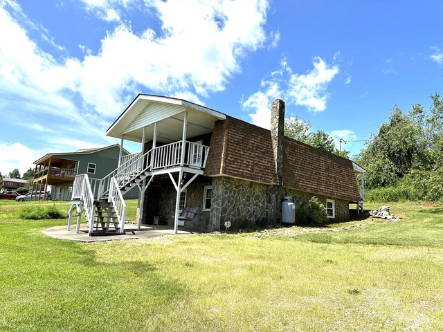 542 Volunteer Rd, Fancy Gap, VA 24328 - back of house with a patio, a chimney, a yard, stairway, and a deck