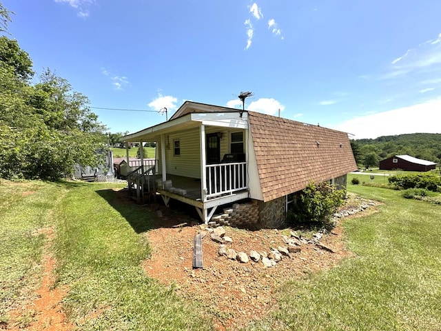 542 Volunteer Rd, Fancy Gap, VA 24328 - view of side of home featuring a lawn, roof with shingles, and a porch