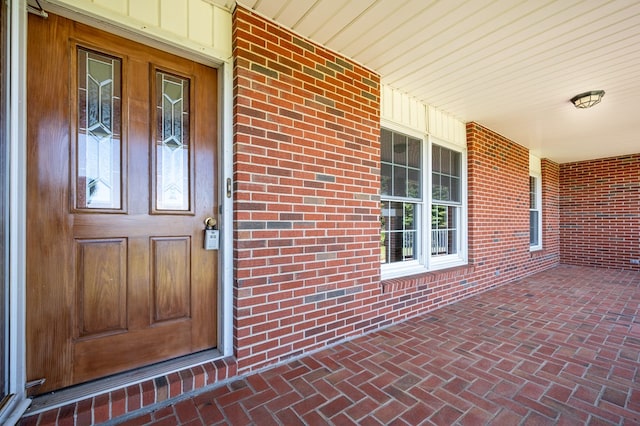 8214 Snake Creek Rd, Hillsville, VA 24343 - view of exterior entry featuring covered porch and brick siding