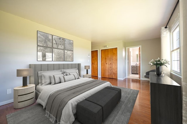8214 Snake Creek Rd, Hillsville, VA 24343 - bedroom with dark wood finished floors, ensuite bathroom, and multiple closets