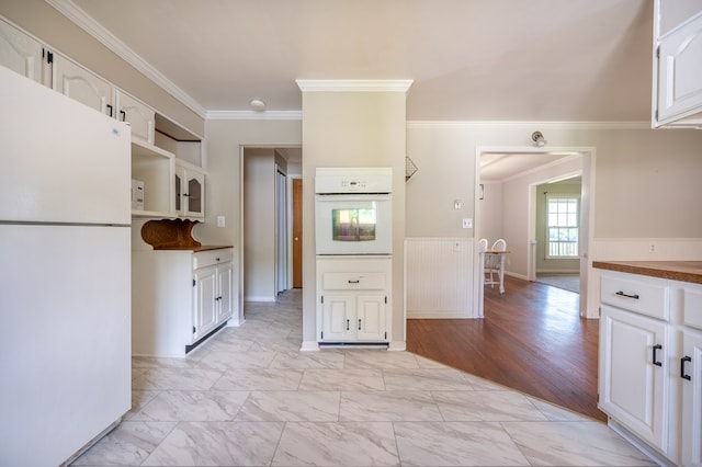 8214 Snake Creek Rd, Hillsville, VA 24343 - kitchen with white appliances, crown molding, white cabinetry, wainscoting, and open shelves