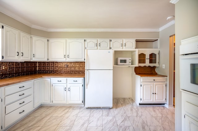 8214 Snake Creek Rd, Hillsville, VA 24343 - kitchen featuring white appliances, white cabinets, crown molding, backsplash, and light marble finish floors