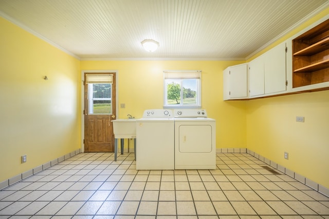 8214 Snake Creek Rd, Hillsville, VA 24343 - laundry area with cabinet space, washer and dryer, healthy amount of natural light, ornamental molding, and light tile patterned flooring
