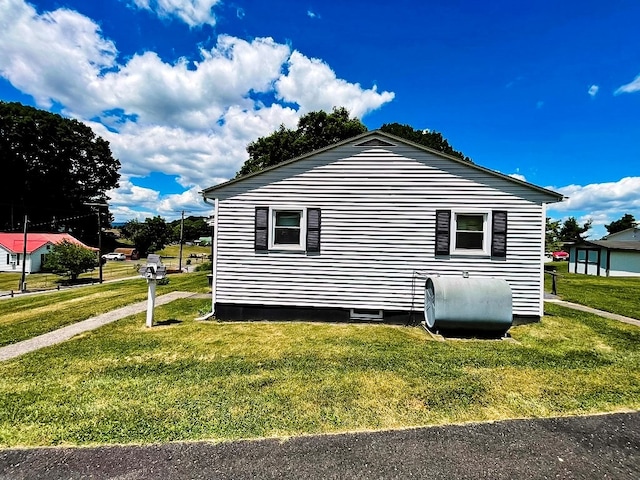 view of home's exterior with a lawn and heating fuel