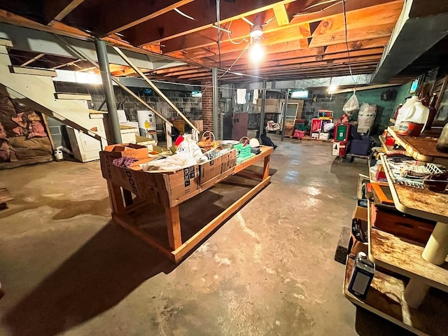 unfinished below grade area featuring stairway and water heater