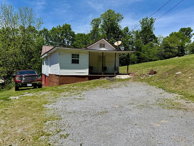 318 Limestone Rd, Pounding Mill, VA 24637 - bungalow-style home featuring a porch, a front lawn, and metal roof