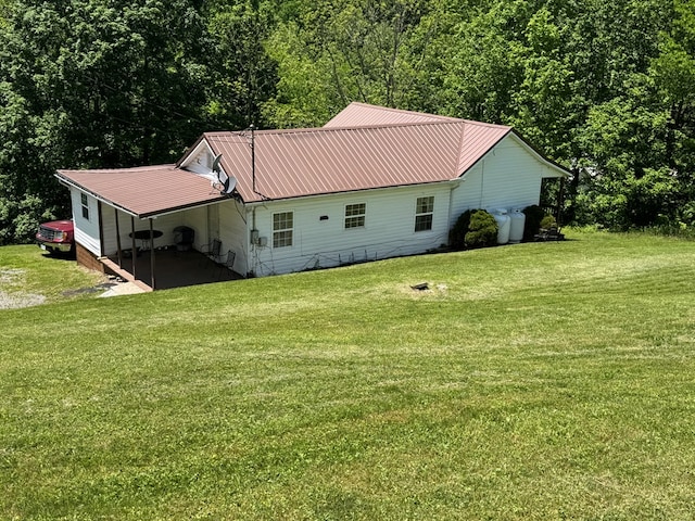 318 Limestone Rd, Pounding Mill, VA 24637 - rear view of property featuring a lawn, metal roof, and a view of trees