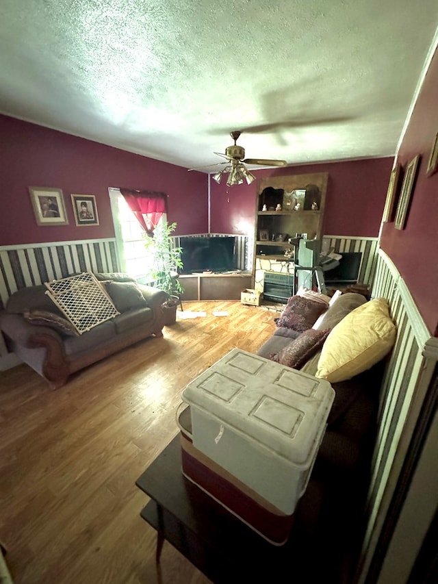 318 Limestone Rd, Pounding Mill, VA 24637 - living room with a ceiling fan, a textured ceiling, and wood finished floors