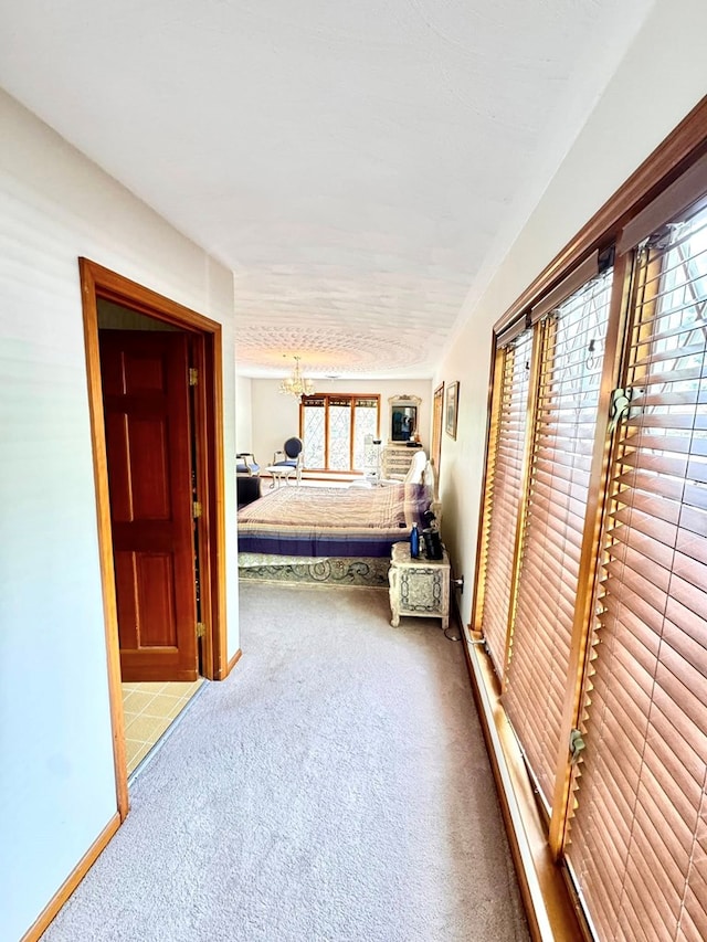1595 Edgewater Dr, Grundy, VA 24614 - carpeted bedroom featuring a chandelier and baseboards