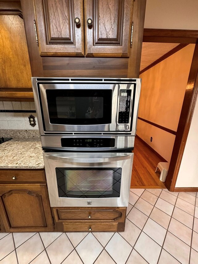 1595 Edgewater Dr, Grundy, VA 24614 - kitchen featuring appliances with stainless steel finishes, light tile patterned flooring, and backsplash