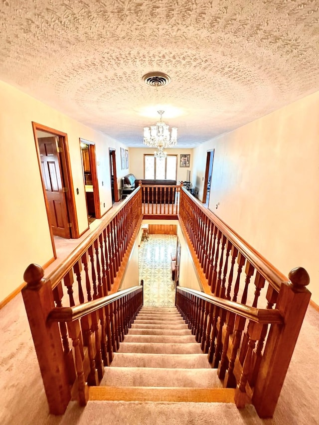 1595 Edgewater Dr, Grundy, VA 24614 - staircase featuring carpet floors and a chandelier