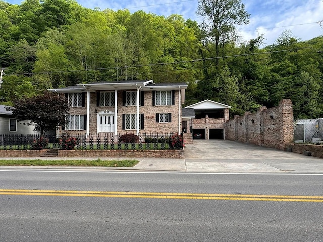 1595 Edgewater Dr, Grundy, VA 24614 - view of front of home with concrete driveway, fence, a garage, and brick siding