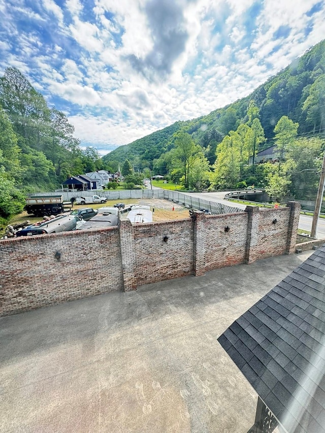 1595 Edgewater Dr, Grundy, VA 24614 - view of patio / terrace with a mountain view, fence, and a forest view