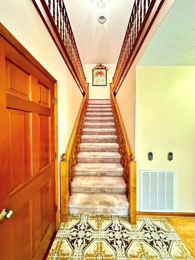 1595 Edgewater Dr, Grundy, VA 24614 - stairway with a textured ceiling