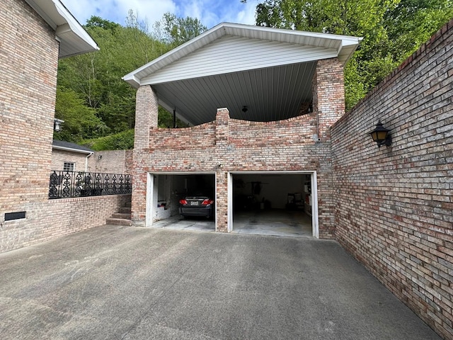 1595 Edgewater Dr, Grundy, VA 24614 - view of side of property featuring driveway, brick siding, and an attached garage