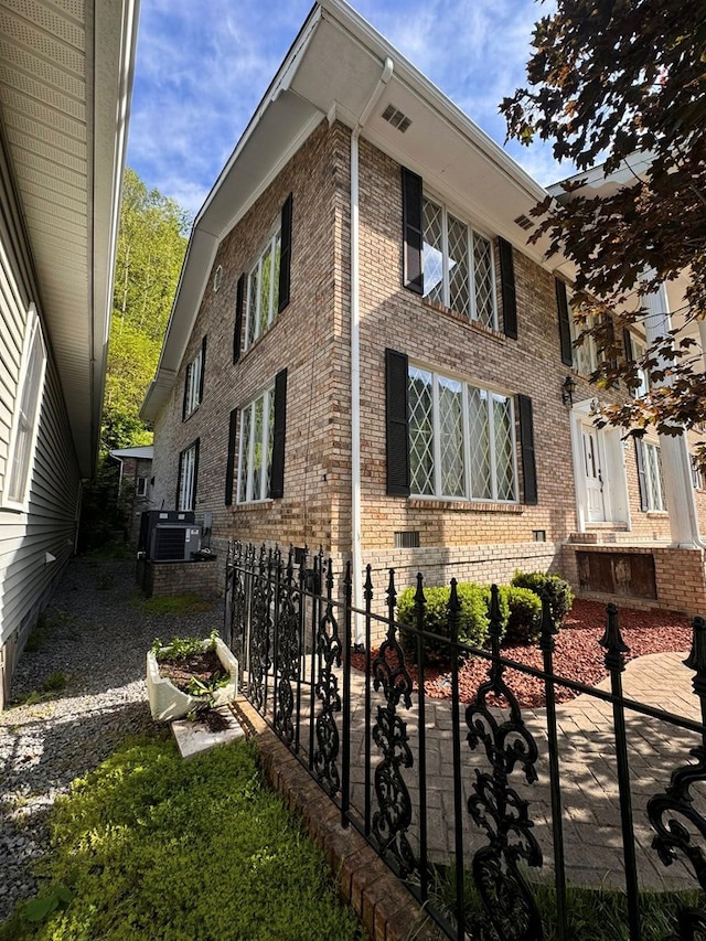 1595 Edgewater Dr, Grundy, VA 24614 - view of side of home with central AC unit and brick siding