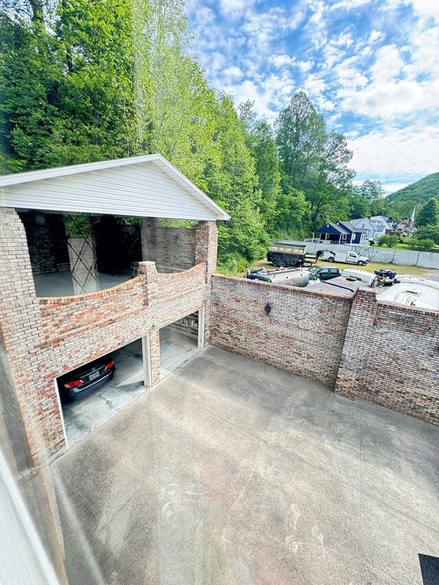 1595 Edgewater Dr, Grundy, VA 24614 - view of patio featuring driveway and an attached garage