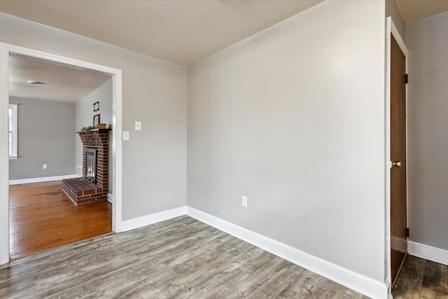 409 Crescent Dr, Glade Spring, VA 24340 - unfurnished living room with wood finished floors, baseboards, and a fireplace