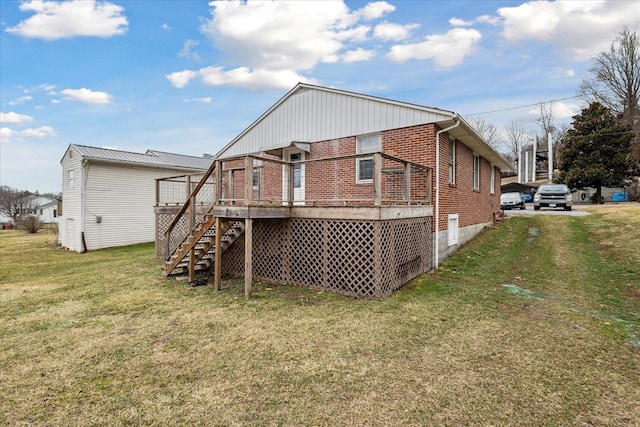 409 Crescent Dr, Glade Spring, VA 24340 - rear view of house featuring brick siding, stairs, a wooden deck, and a lawn