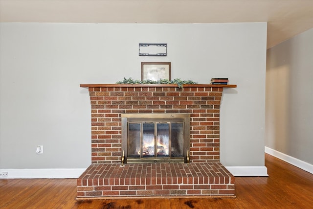 409 Crescent Dr, Glade Spring, VA 24340 - detailed view of baseboards, a fireplace, and wood finished floors