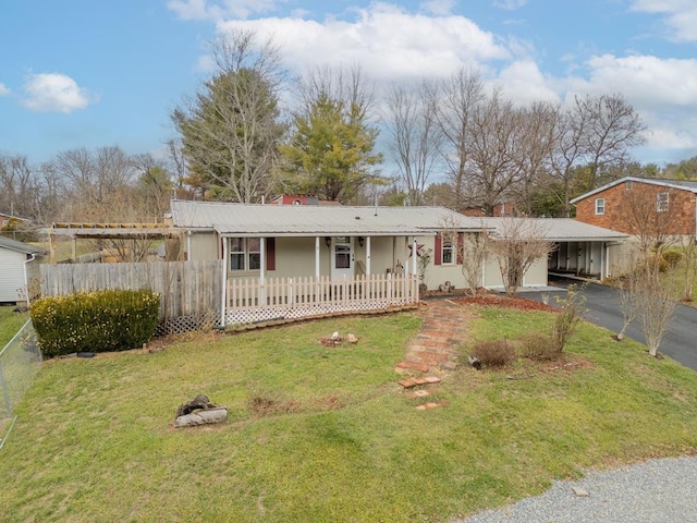 ranch-style home with a front lawn, a carport, and covered porch