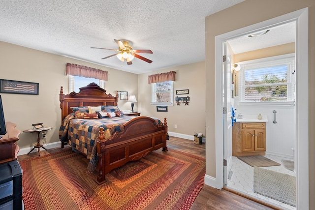 7268 Southern View Rd, Bristol, VA 24202 - bedroom featuring a textured ceiling, baseboards, a ceiling fan, and wood finished floors