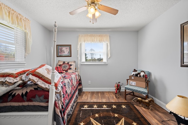 7268 Southern View Rd, Bristol, VA 24202 - bedroom featuring a textured ceiling, multiple windows, and wood finished floors