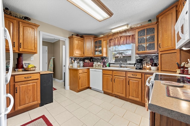 7268 Southern View Rd, Bristol, VA 24202 - kitchen featuring brown cabinetry, white appliances, tasteful backsplash, and a sink