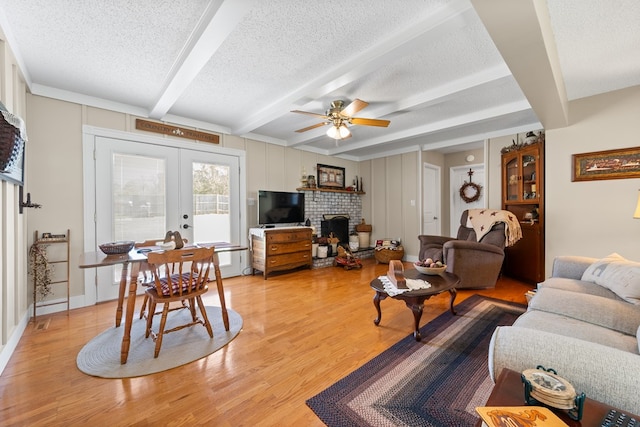 7268 Southern View Rd, Bristol, VA 24202 - living area featuring light wood finished floors, a textured ceiling, french doors, and a ceiling fan