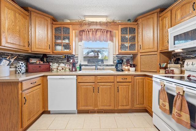7268 Southern View Rd, Bristol, VA 24202 - kitchen with decorative backsplash, visible vents, a sink, and white appliances