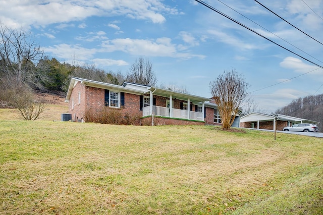 ranch-style home with a porch, cooling unit, brick siding, and a front lawn