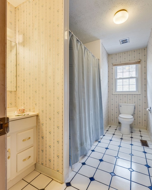 bathroom featuring wallpapered walls, visible vents, toilet, curtained shower, and a textured ceiling