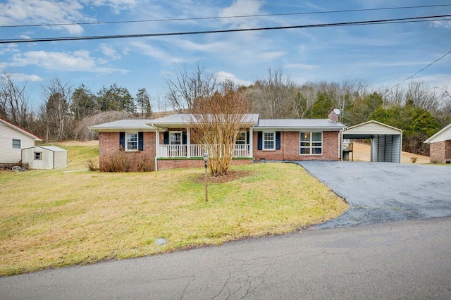 single story home featuring aphalt driveway, a front yard, covered porch, and brick siding