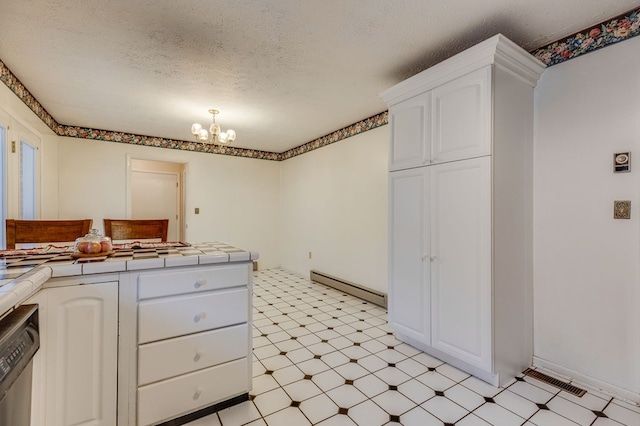 kitchen with tile counters, dishwasher, baseboard heating, light floors, and a chandelier