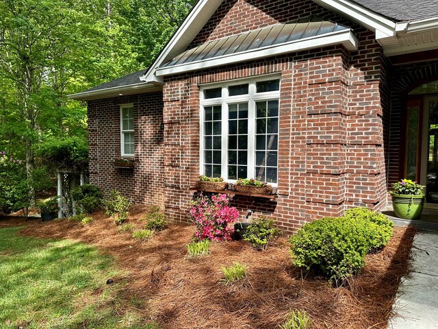 23677 Archery Range Rd, Bristol, VA 24202 - view of side of home with a standing seam roof, brick siding, a metal roof, and a shingled roof