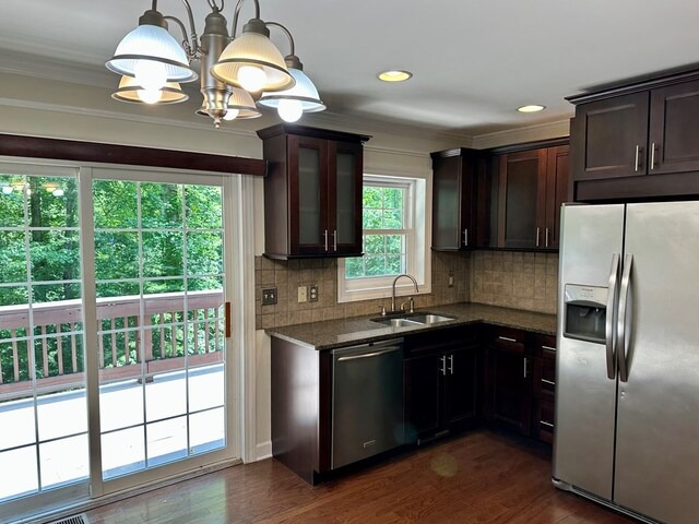 23677 Archery Range Rd, Bristol, VA 24202 - kitchen with appliances with stainless steel finishes, tasteful backsplash, dark brown cabinets, dark stone countertops, and dark wood-style flooring