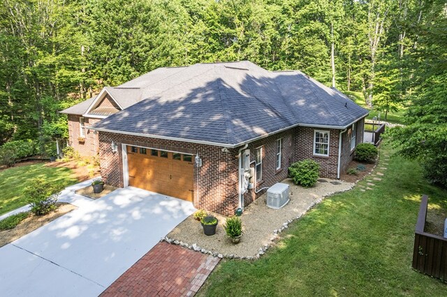 23677 Archery Range Rd, Bristol, VA 24202 - view of front of home featuring an attached garage, brick siding, a wooded view, a shingled roof, and driveway