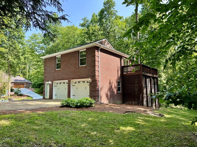 23677 Archery Range Rd, Bristol, VA 24202 - view of property exterior with a garage, brick siding, a lawn, and driveway