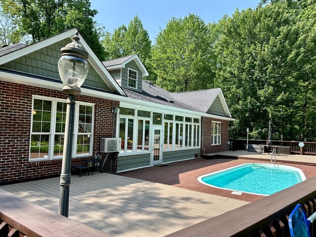 23677 Archery Range Rd, Bristol, VA 24202 - back of house with a deck, brick siding, roof with shingles, and a sunroom