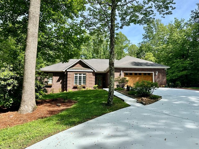 23677 Archery Range Rd, Bristol, VA 24202 - view of front facade with brick siding, concrete driveway, an attached garage, and a front lawn