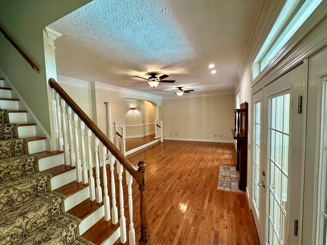 23677 Archery Range Rd, Bristol, VA 24202 - entryway with a ceiling fan, a textured ceiling, arched walkways, light wood-type flooring, and ornamental molding