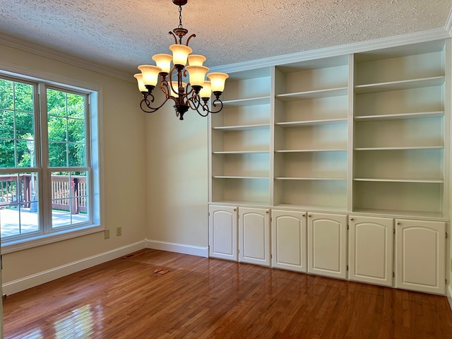 23677 Archery Range Rd, Bristol, VA 24202 - unfurnished dining area featuring a chandelier, wood finished floors, a textured ceiling, and crown molding