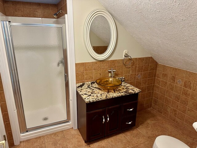 23677 Archery Range Rd, Bristol, VA 24202 - bathroom featuring tile walls, a textured ceiling, a shower stall, vanity, and tile patterned floors