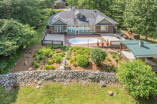 23677 Archery Range Rd, Bristol, VA 24202 - back of property featuring a deck, brick siding, an empty pool, and a patio