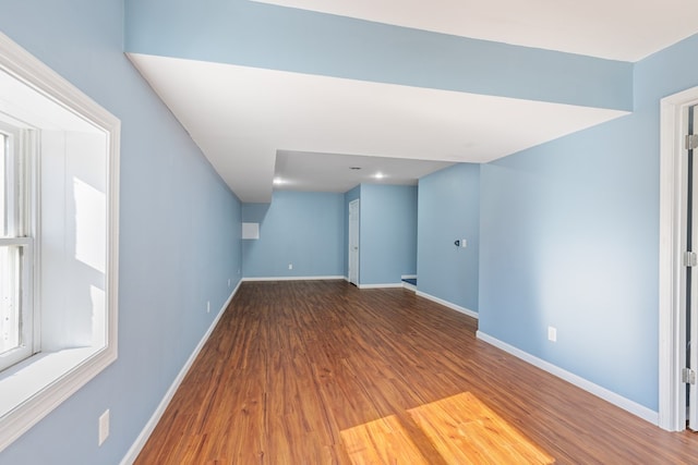below grade area featuring baseboards and wood finished floors