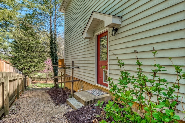 view of side of home featuring fence