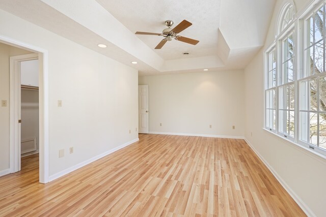 unfurnished room featuring baseboards, ceiling fan, and light wood-type flooring