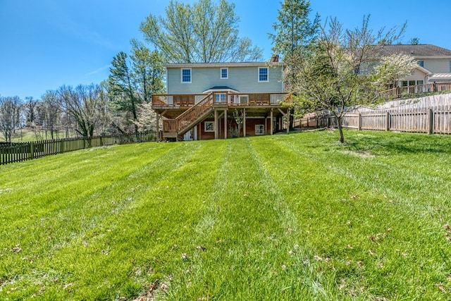 back of property with stairway, a deck, a yard, and a fenced backyard