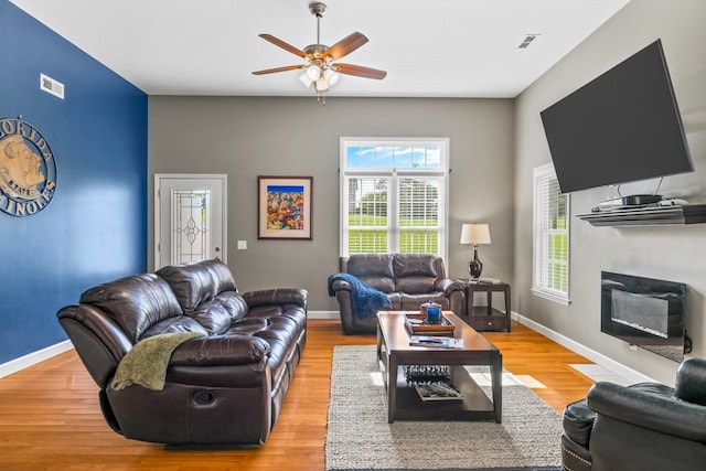 living room with ceiling fan and light wood-type flooring