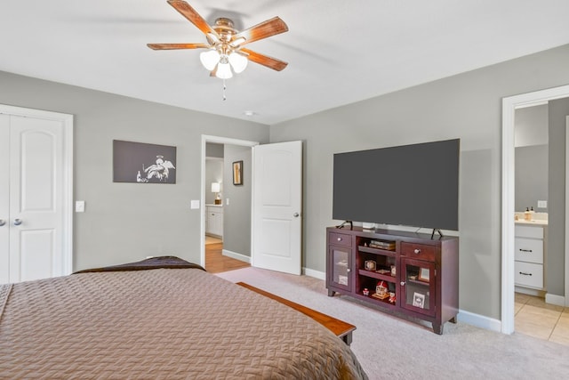 carpeted bedroom with connected bathroom and ceiling fan